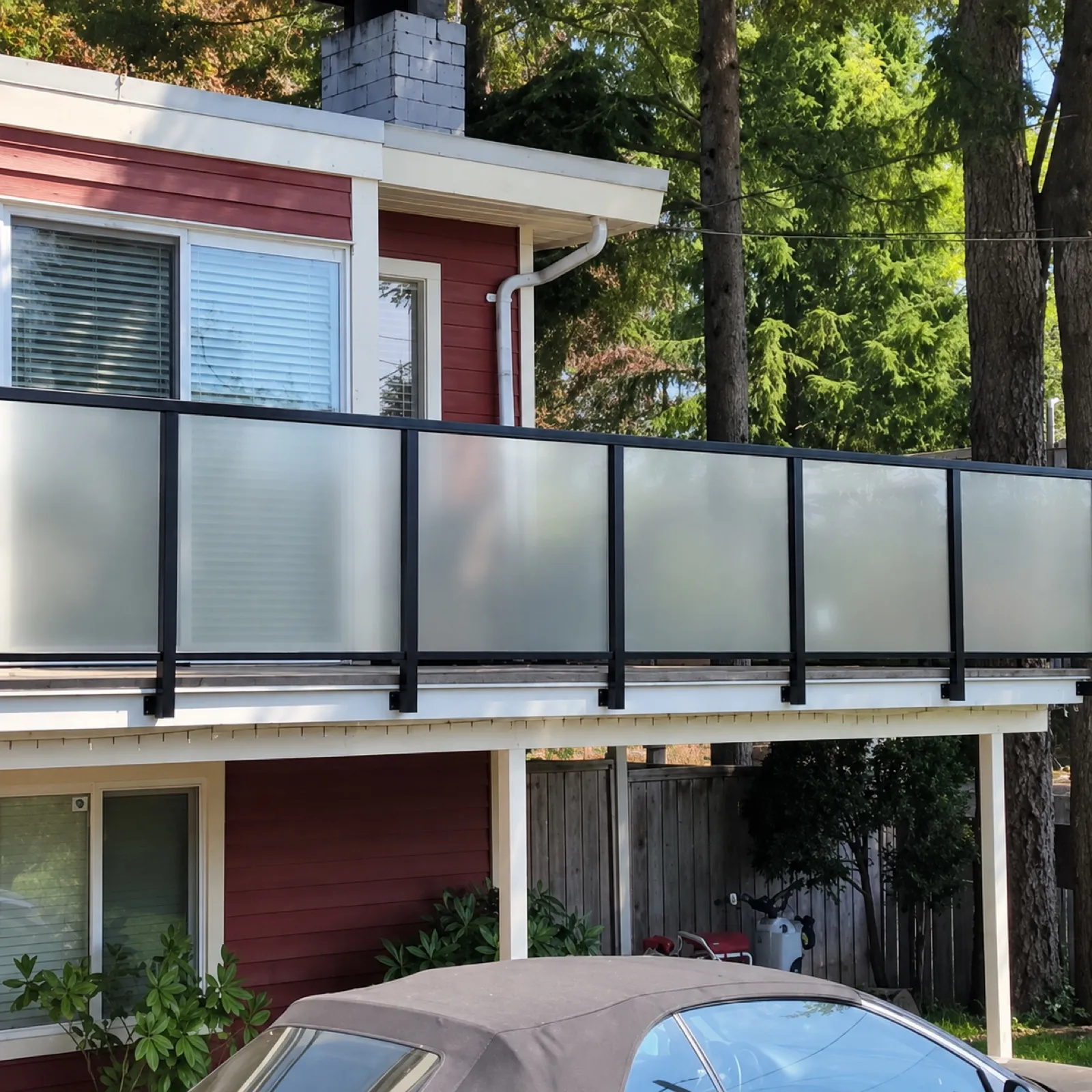 Wide deck stairs with matching railings running down to a landscaped yard